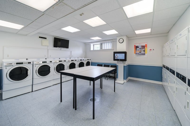 Westover House laundry room with washers, dryers, and folding table in the middle